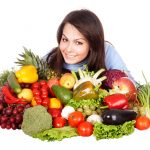 Girl with group of fruit and vegetables. Isolated.