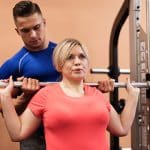 woman-lifting-weights-with-trainer