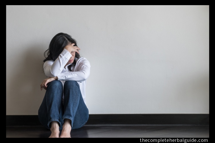 Adobe Stock royalty-free image #199661480, 'Panic attack, anxiety disorder menopause woman, stressful depressed emotional person with mental health illness, headache and migraine sitting back against wall on the floor in domestic home' uploaded by Chinnapong, standard license purchased from https://stock.adobe.com/images/download/199661480; file retrieved on May 23rd, 2019. License details available athttps://stock.adobe.com/license-terms - image is licensed under the Adobe Stock Standard License